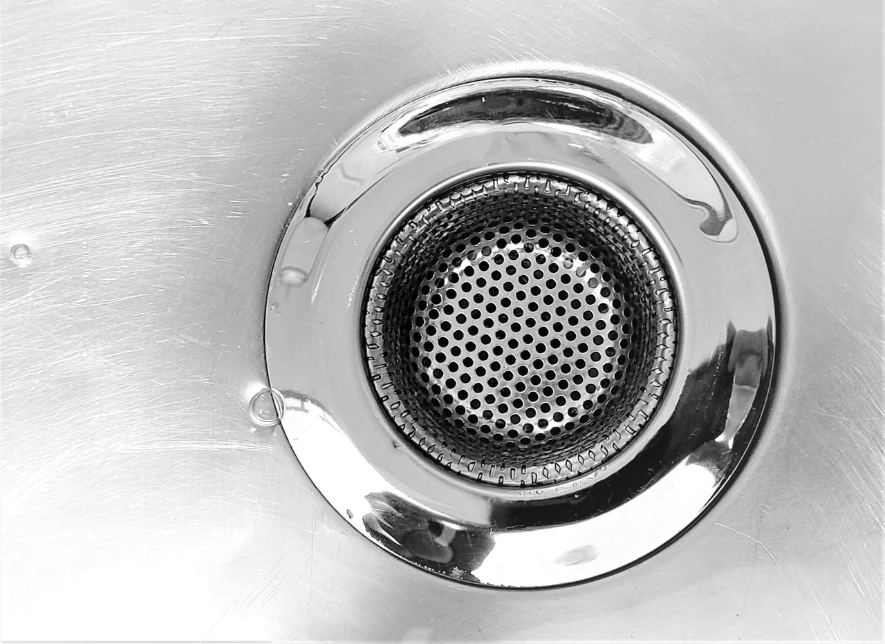 Close view of a perforated metal sink drain
